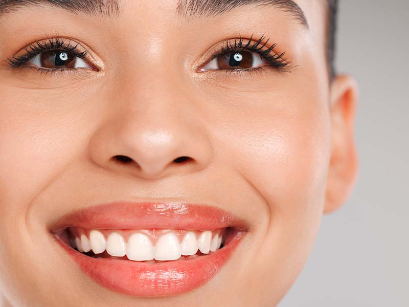 Woman smiling against a bright studio background