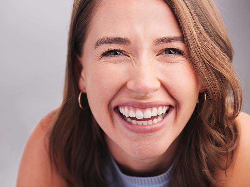 Woman laughing with a relaxed smile
