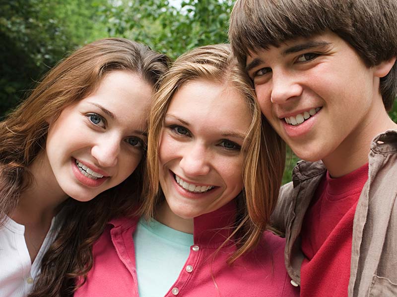 Teen friends smiling outdoors