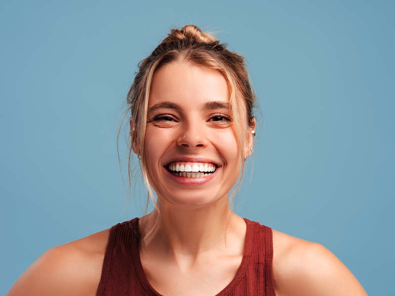 Active woman smiling against a blue background