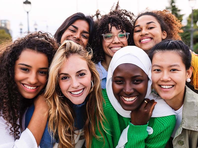 Diverse group of women smiling together