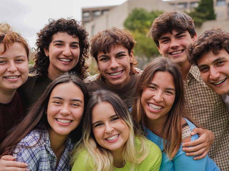 Group of young adults smiling outdoors