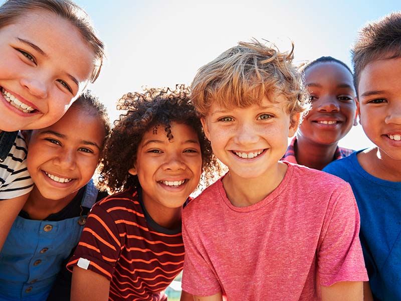 Preteen friends smiling outdoors