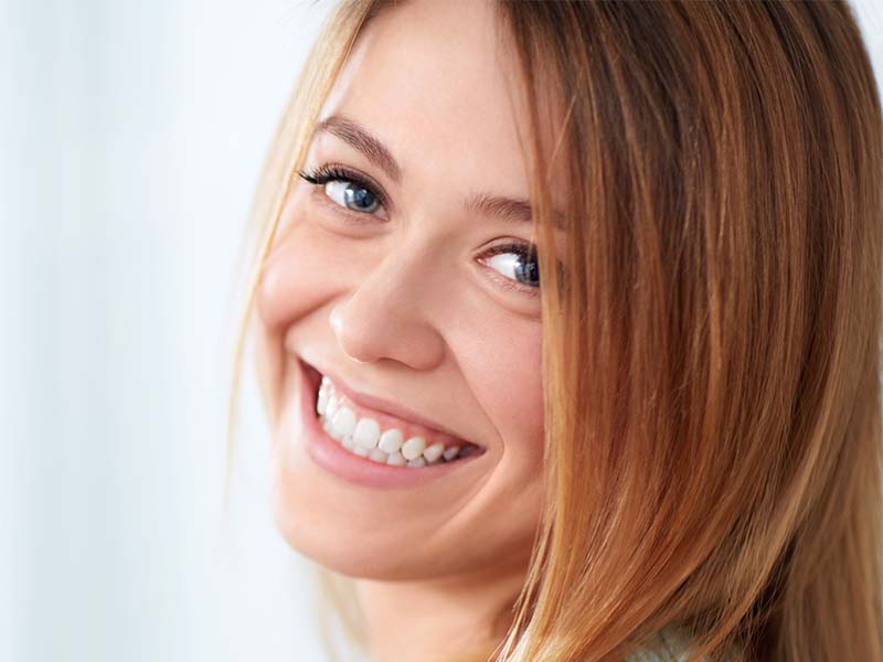 Woman smiling in a bright indoor setting