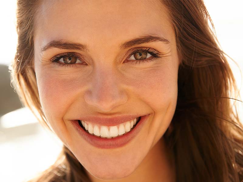 Woman smiling in warm outdoor light